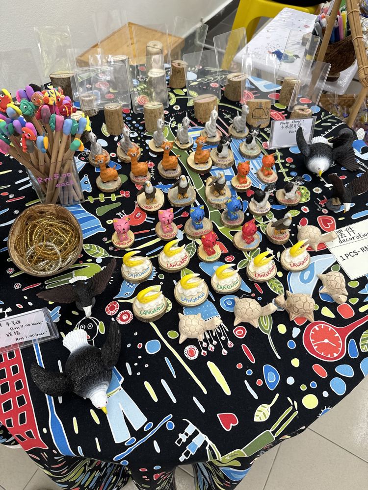 Handmade souvenirs on a batik cloth table at Moon Langkawi Souvenir